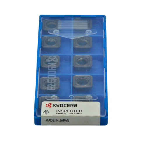 Kyocera SEKT1204AFEN-S inserts arranged in a tray, emphasizing high-efficiency shoulder milling design