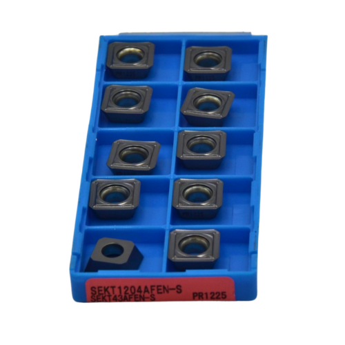 Top view of 10 Kyocera SEKT1204AFEN-S milling inserts showing sharp edges for high-efficiency shoulder milling